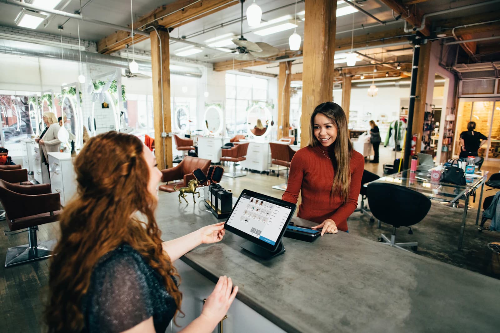 Two colleagues collaborating at a worktable — an SMB team starting their chatbot implementation